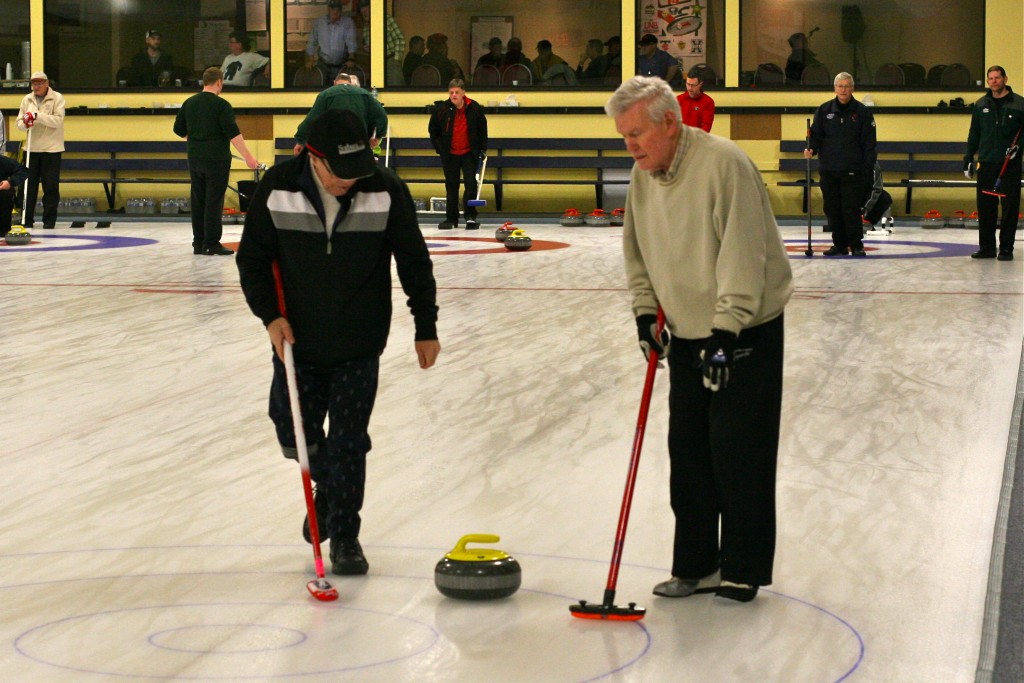 Dave Cain waits for Norm Green to call for sweeping.
